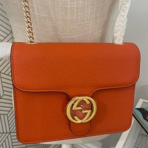Orange leather crossbody purse with gold chain